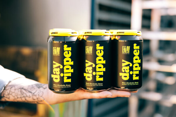 Hand holding 6-Pack of non-alcoholic Pilsner